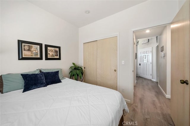 bedroom featuring light hardwood / wood-style flooring and a closet