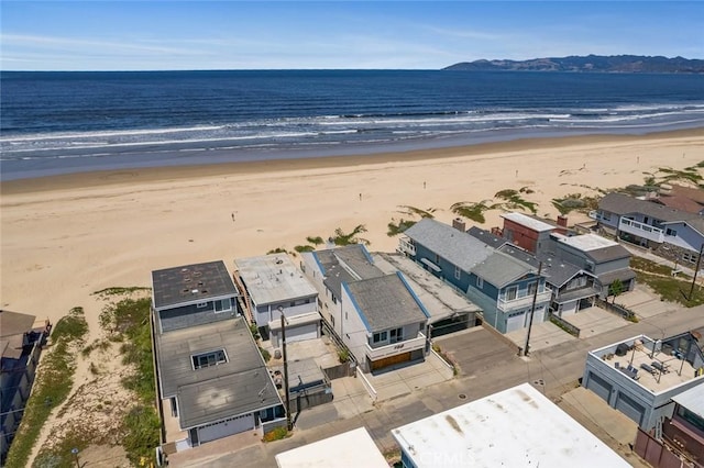 drone / aerial view featuring a view of the beach and a water view