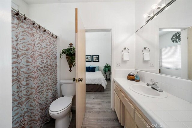 1652 Strand Way, Oceano, CA 93445 - full bathroom featuring vanity, wood finished floors, backsplash, and ensuite bath