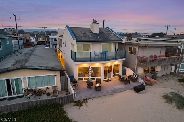 1652 Strand Way, Oceano, CA 93445 - back of property with a balcony, a chimney, a deck, stucco siding, and a residential view