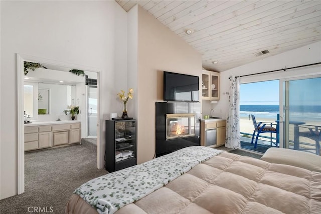 carpeted bedroom featuring sink, wine cooler, access to exterior, connected bathroom, and wood ceiling