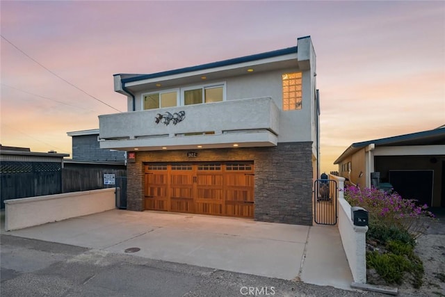 modern home featuring a garage and a balcony