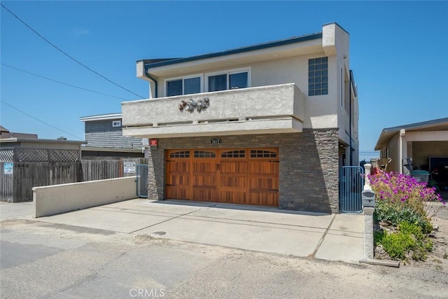 view of front facade featuring a balcony and a garage