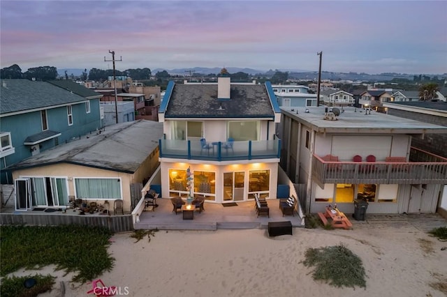 1652 Strand Way, Oceano, CA 93445 - rear view of house featuring a balcony, a chimney, an outdoor living space, stucco siding, and a residential view