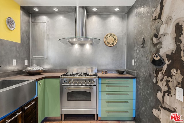 kitchen with butcher block counters, sink, and stainless steel stove