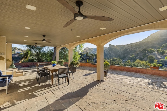 view of patio with a mountain view and ceiling fan