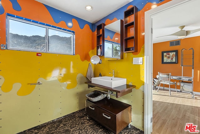 bathroom featuring wood-type flooring, ceiling fan, and sink