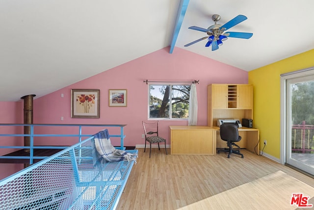 office area with lofted ceiling with beams, light hardwood / wood-style floors, a wood stove, and ceiling fan