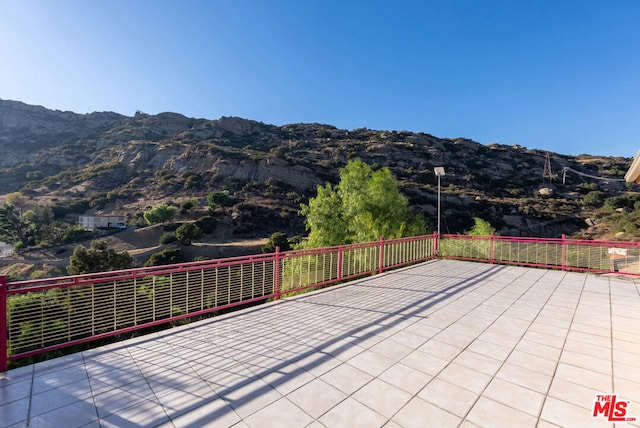 view of patio / terrace featuring a mountain view