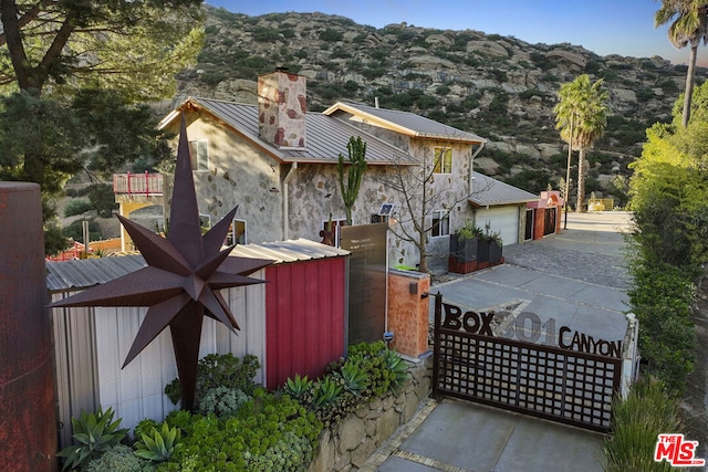 view of side of property with a mountain view and a garage