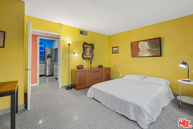 bedroom featuring stainless steel fridge with ice dispenser