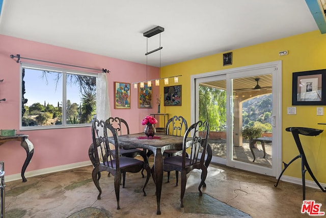 dining space featuring concrete floors