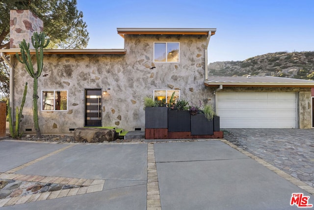 view of front of house with a mountain view and a garage