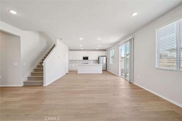 unfurnished living room with light hardwood / wood-style floors