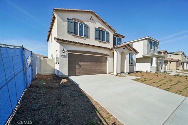 mediterranean / spanish-style home with a garage