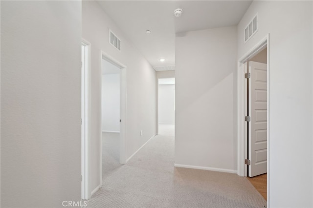 hall with light colored carpet