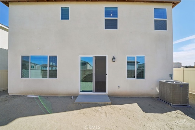 rear view of property featuring central AC