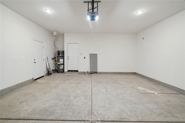 garage featuring secured water heater and a garage door opener