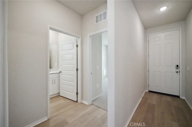 corridor with light hardwood / wood-style flooring