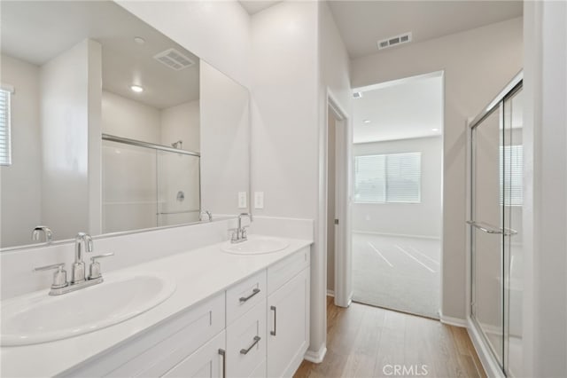 bathroom with vanity, hardwood / wood-style floors, and walk in shower