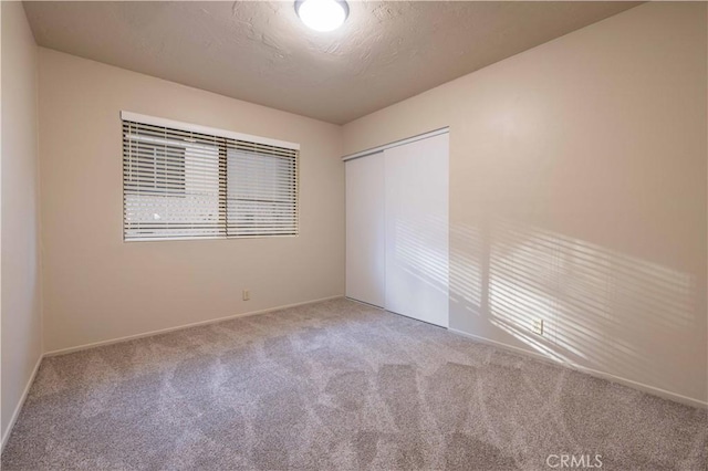 empty room featuring carpet floors and a textured ceiling