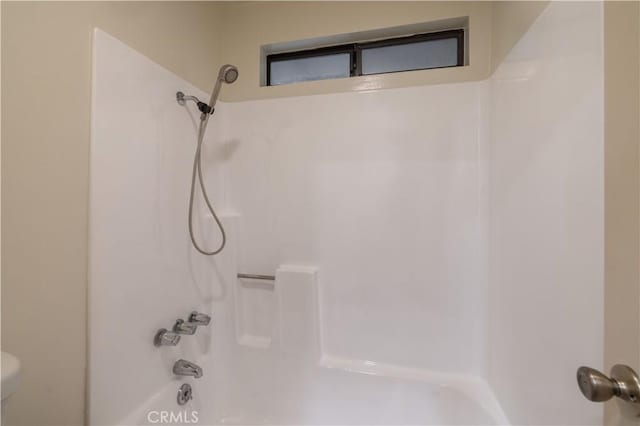 bathroom with shower / bathtub combination and toilet