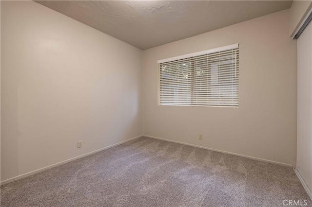 2028 Manzanita Ln, Big Bear City, CA 92314 - carpeted empty room with baseboards