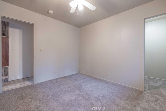 unfurnished bedroom with light colored carpet and ceiling fan