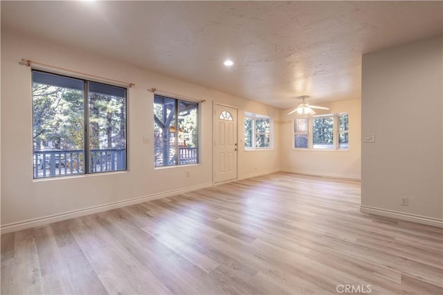 unfurnished room with light hardwood / wood-style floors and ceiling fan