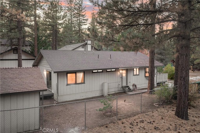 view of back house at dusk