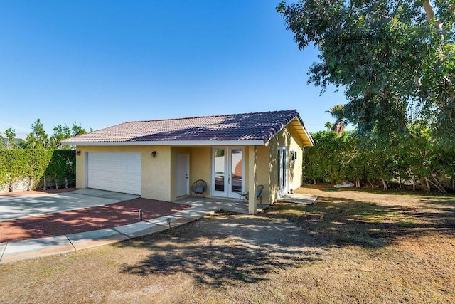 view of front of property featuring a garage and french doors