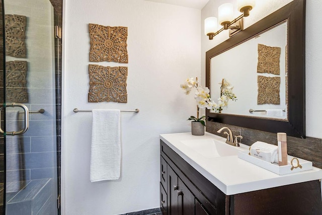 bathroom with vanity and a shower with shower door