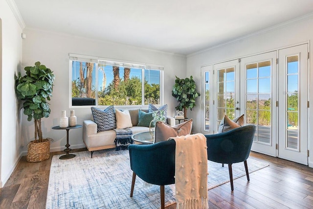 sitting room featuring hardwood / wood-style floors, crown molding, and french doors