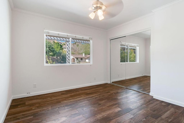 unfurnished room with ceiling fan, dark hardwood / wood-style flooring, and ornamental molding