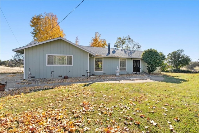 rear view of house with a yard