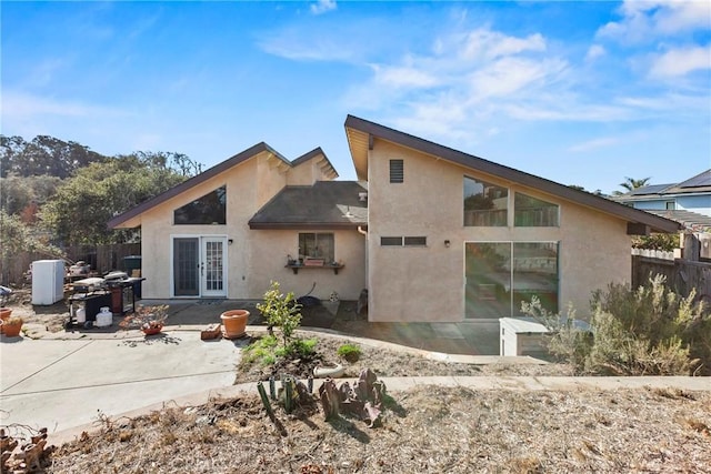 rear view of property featuring a patio and french doors