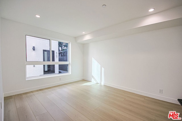 unfurnished room with light wood-type flooring