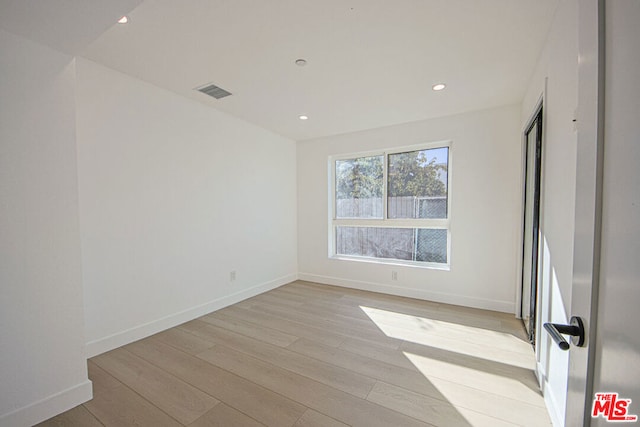 spare room featuring light hardwood / wood-style flooring