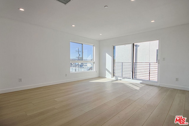 unfurnished room featuring light hardwood / wood-style floors