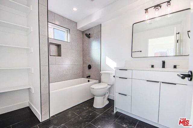 full bathroom with vanity, tiled shower / bath combo, and toilet