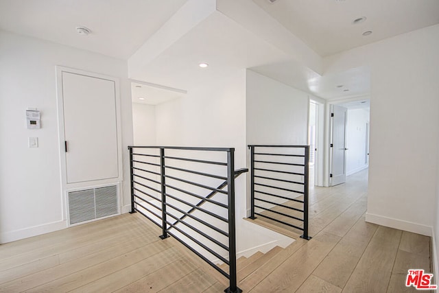 stairs with hardwood / wood-style flooring