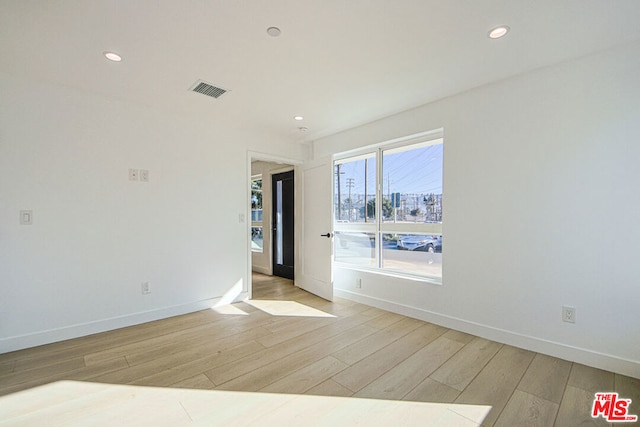 spare room featuring light hardwood / wood-style floors