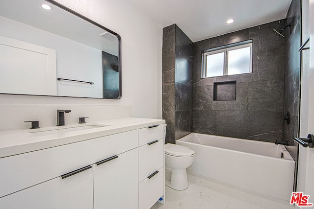 full bathroom with vanity, toilet, and tiled shower / bath