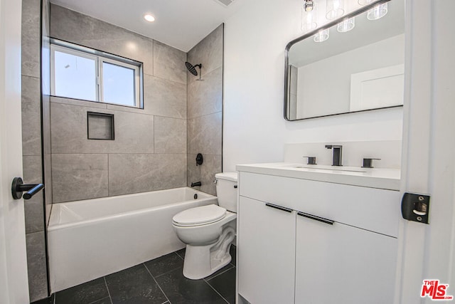 full bathroom with tile patterned flooring, vanity, toilet, and tiled shower / bath