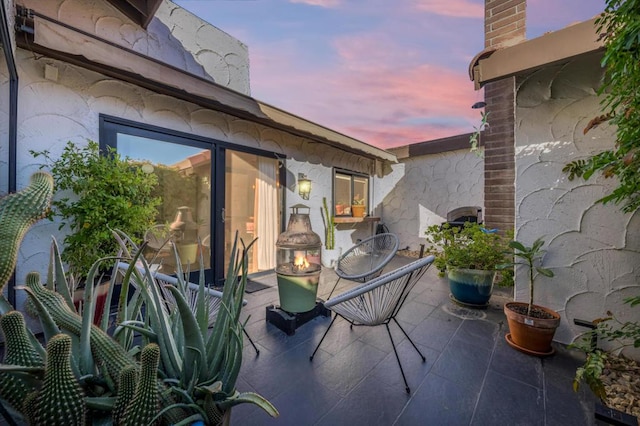 view of patio terrace at dusk