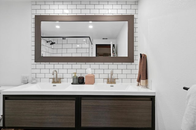 bathroom with vanity, a shower, and tasteful backsplash