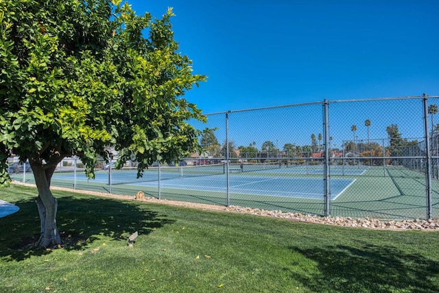 view of sport court featuring a lawn