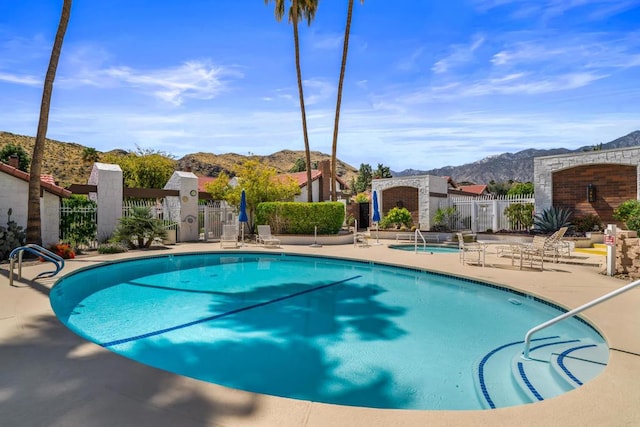 view of swimming pool with a mountain view and a patio