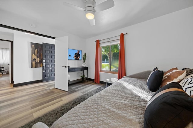 bedroom featuring hardwood / wood-style floors and ceiling fan