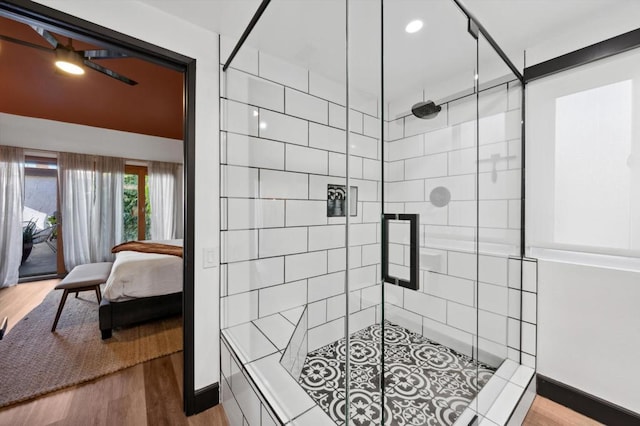 bathroom featuring hardwood / wood-style floors and a shower with door